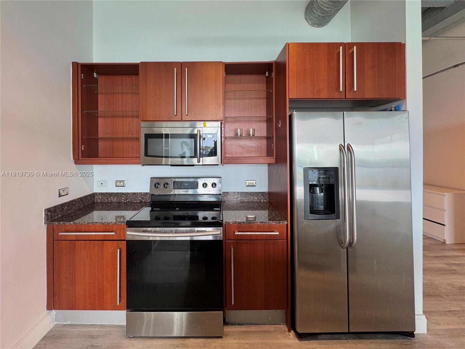 8101 Biscayne Boulevard, Unit R615 Miami, FL 33138 - Photo 8 of 27 a kitchen with a refrigerator sink and microwave