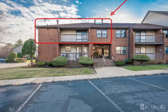 a front view of brick house with a yard