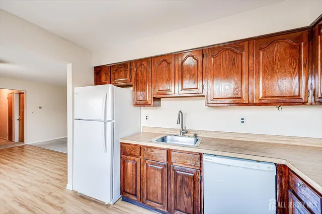 a kitchen with stainless steel appliances granite countertop a refrigerator sink and cabinets
