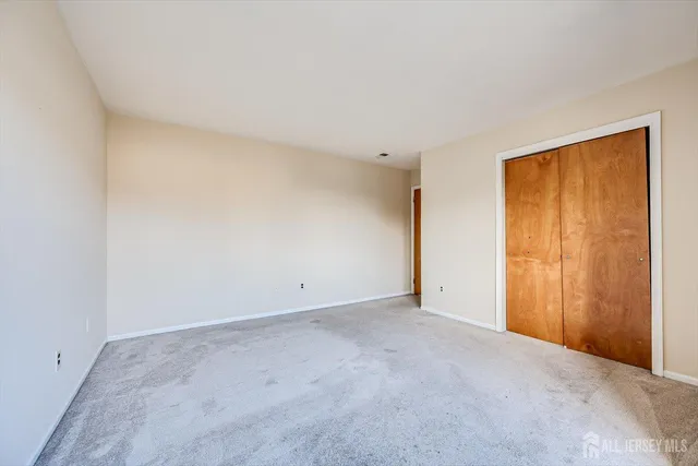 a view of an empty room and a window