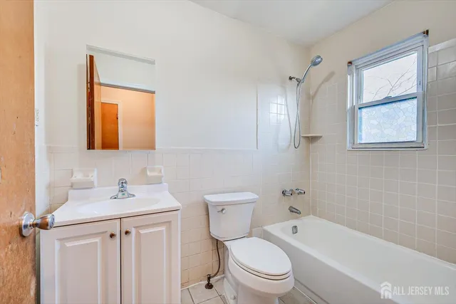 a bathroom with a granite countertop toilet a sink and a bathtub