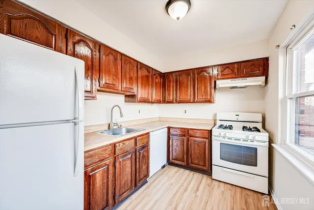 a kitchen with a white cabinets and white appliances