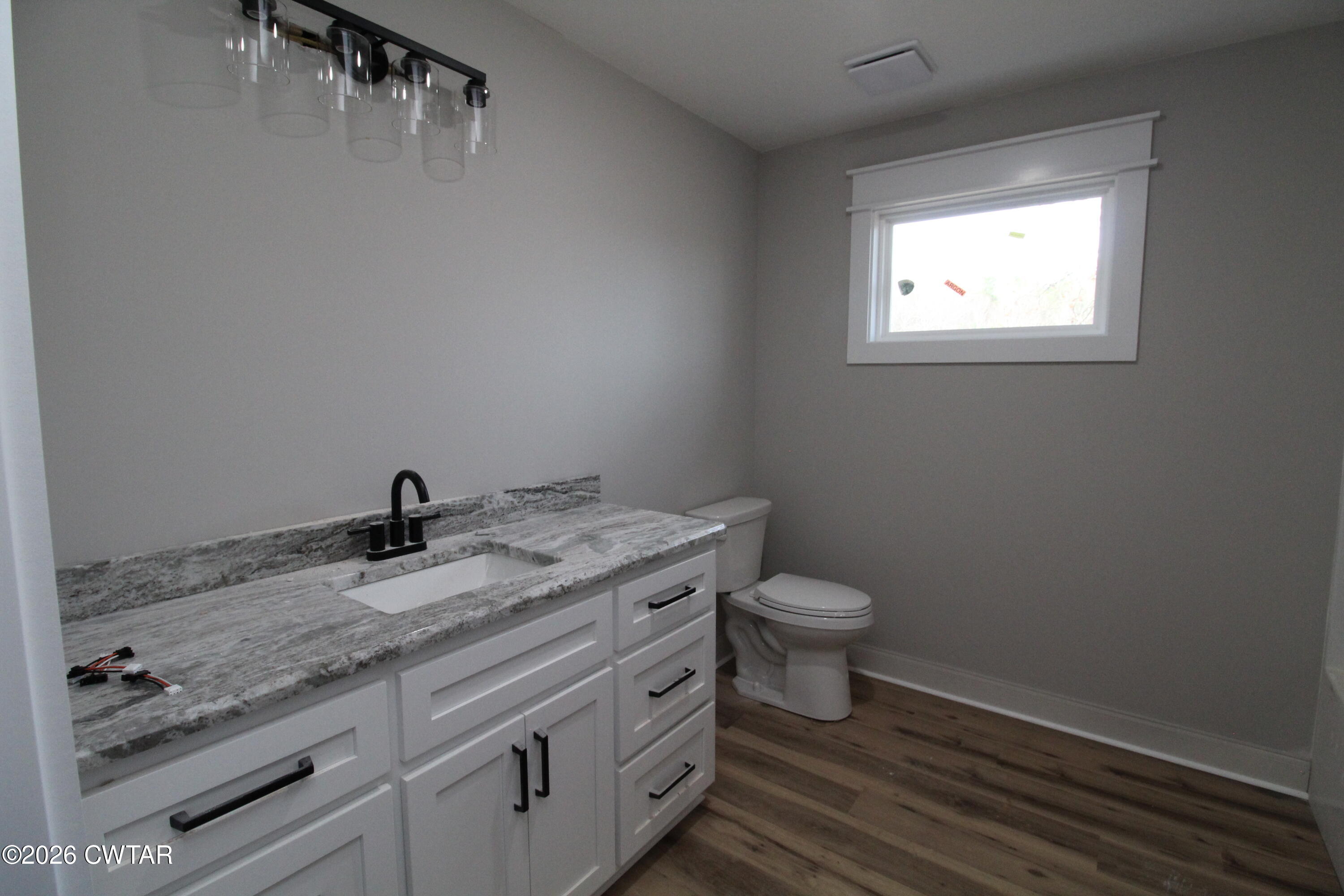 440 Oak Point Drive Lexington, TN 38351 - Photo 13 of 14 a bathroom with a granite countertop toilet sink and mirror