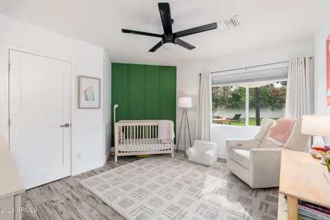 a bedroom with a bed and a large window