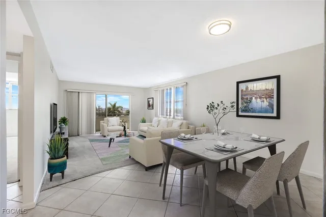 a living room with furniture potted plant and a table