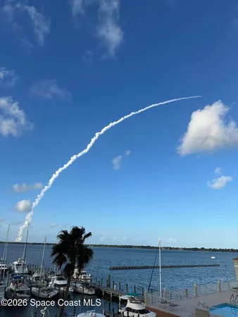 a bathroom with a granite countertop sink a mirror and a shower
