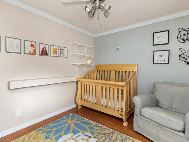 a bedroom with furniture and a wooden floor