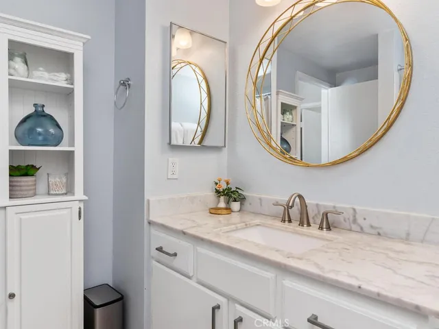 a bathroom with a vanity and a mirror