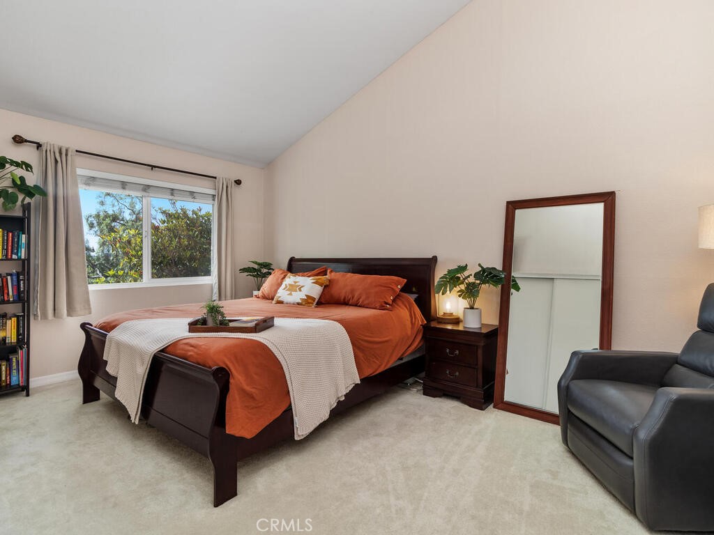 6907 Quail Place, Unit F Carlsbad, CA 92009 - Photo 17 of 24 a bed room with a bed and a couch