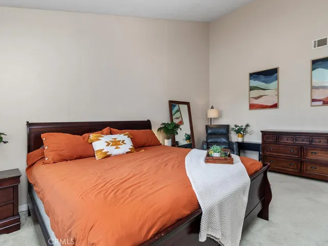 a bedroom with bed and wooden floor