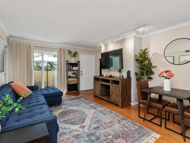a living room with furniture fireplace and flat screen tv