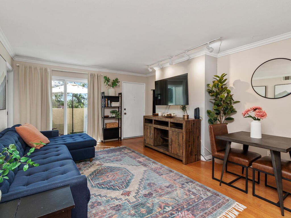 6907 Quail Place, Unit F Carlsbad, CA 92009 - Photo 2 of 24 a living room with furniture fireplace and flat screen tv