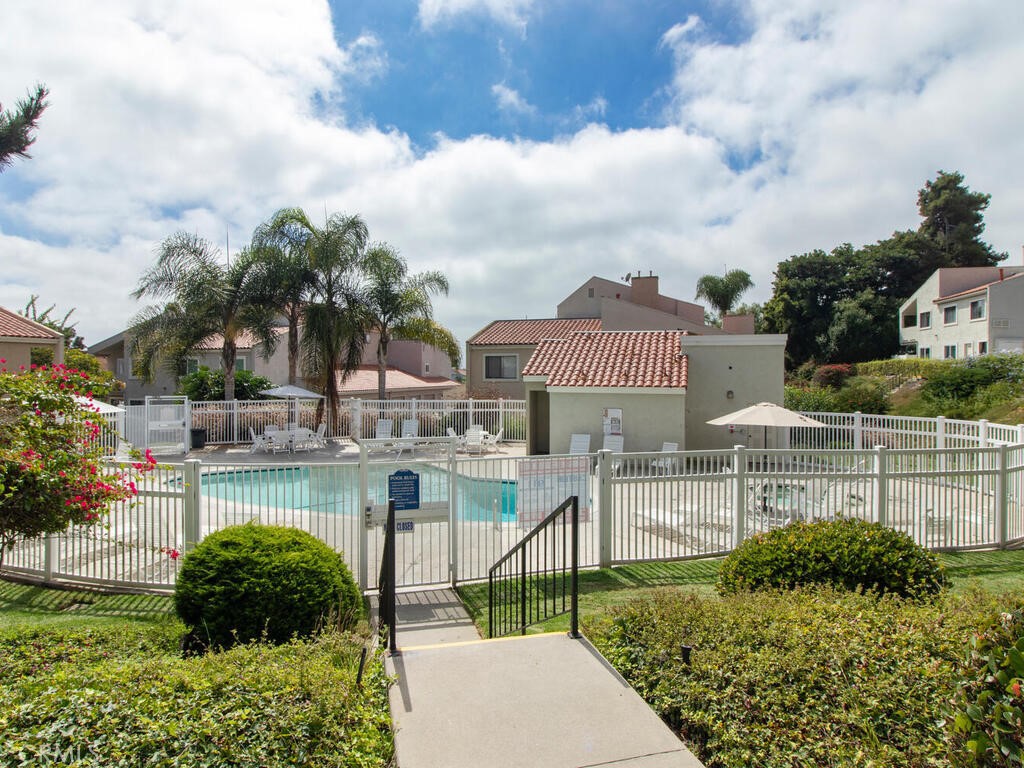 6907 Quail Place, Unit F Carlsbad, CA 92009 - Photo 22 of 24 a view of a swimming pool with a patio and a garden