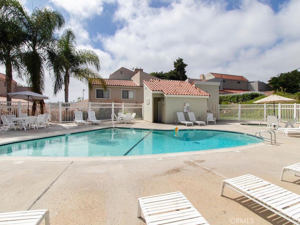 6907 Quail Place, Unit F Carlsbad, CA 92009 - Photo 24 of 24 a view of house with outdoor space and swimming pool