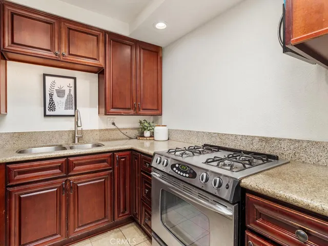 a kitchen with stainless steel appliances granite countertop a stove and a sink