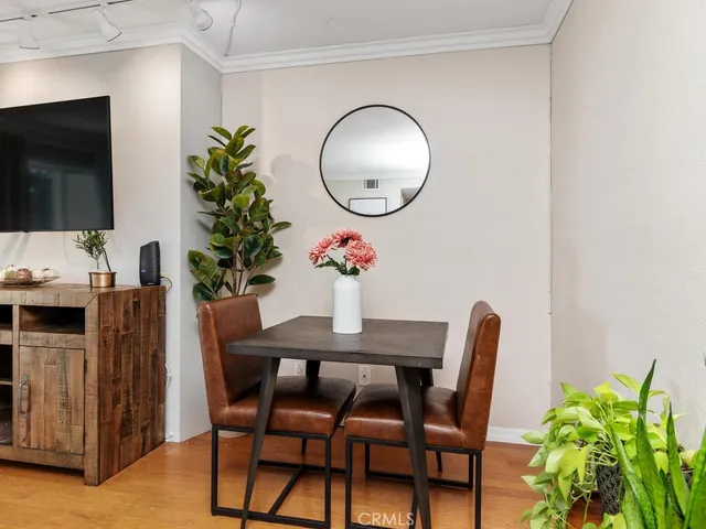 a dining room with furniture and wooden floor
