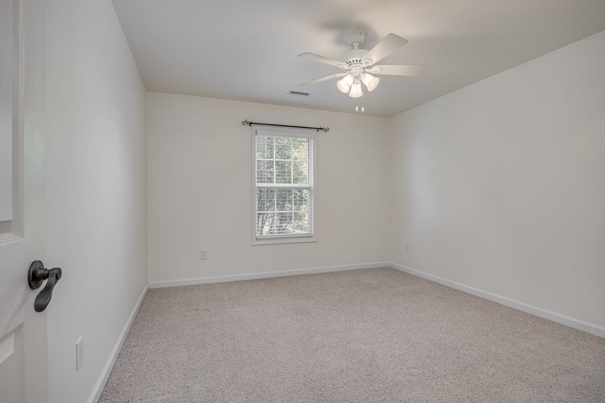 3002 Sakari Circle Spring Hill, TN 37174 - Photo 28 of 56 an empty room with a chandelier fan and windows