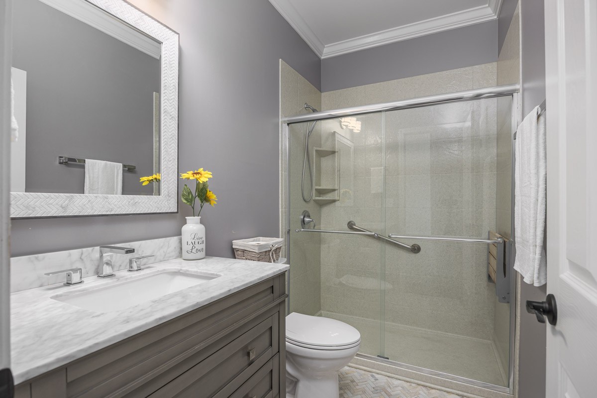 3002 Sakari Circle Spring Hill, TN 37174 - Photo 29 of 56 a bathroom with a granite countertop sink toilet and shower