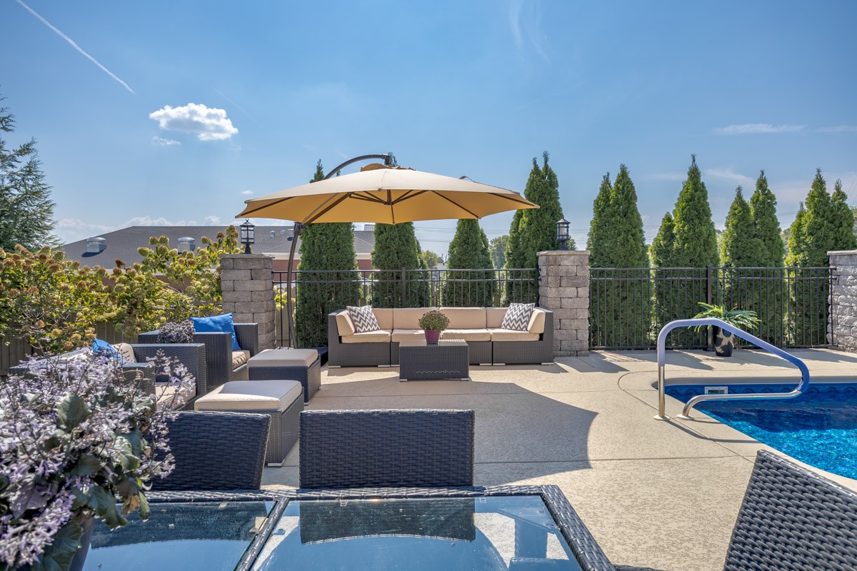 3002 Sakari Circle Spring Hill, TN 37174 - Photo 42 of 56 a view of a patio with couches table and chairs under an umbrella
