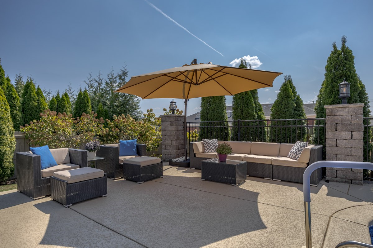 3002 Sakari Circle Spring Hill, TN 37174 - Photo 44 of 56 a view of a patio with couches chairs under an umbrella