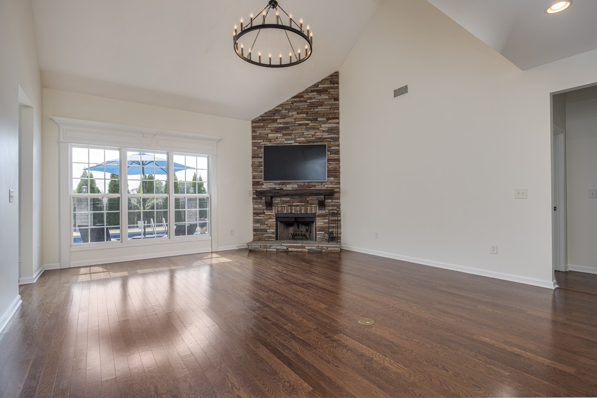 3002 Sakari Circle Spring Hill, TN 37174 - Photo 8 of 56 a view of a livingroom with wooden floor window and a kitchen space