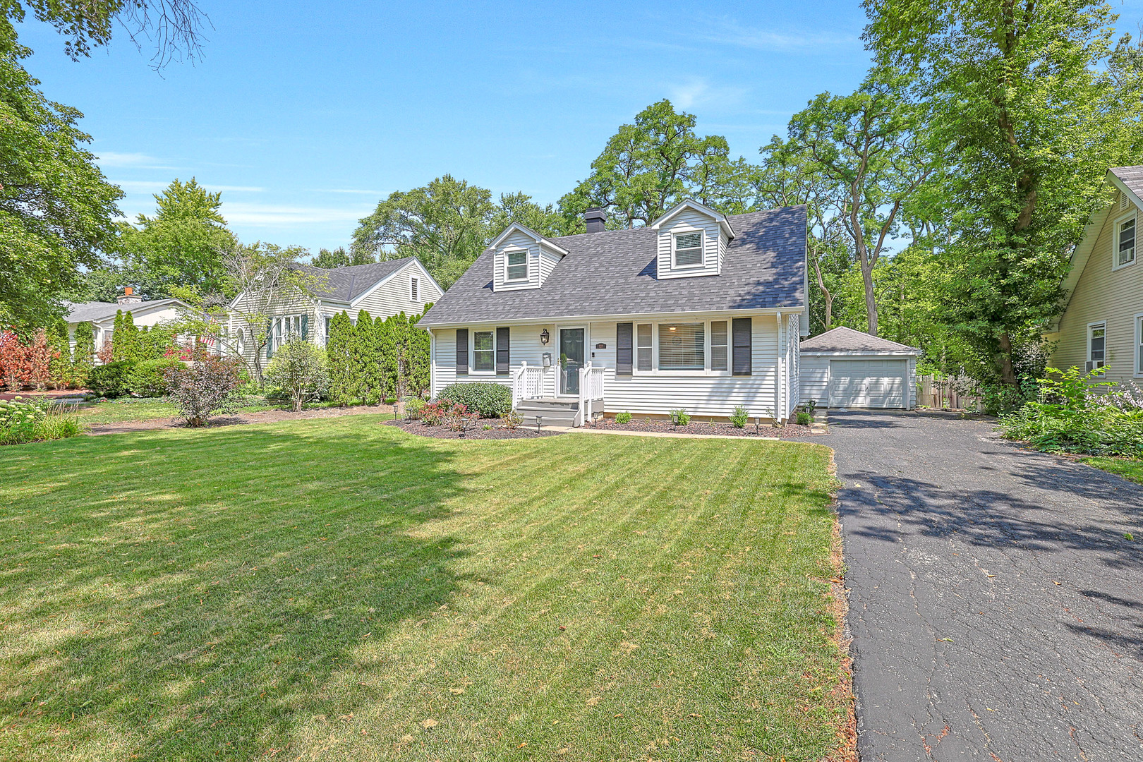 727 South Cook Street Barrington, IL 60010 - Photo 2 of 26 a front view of a house with a garden