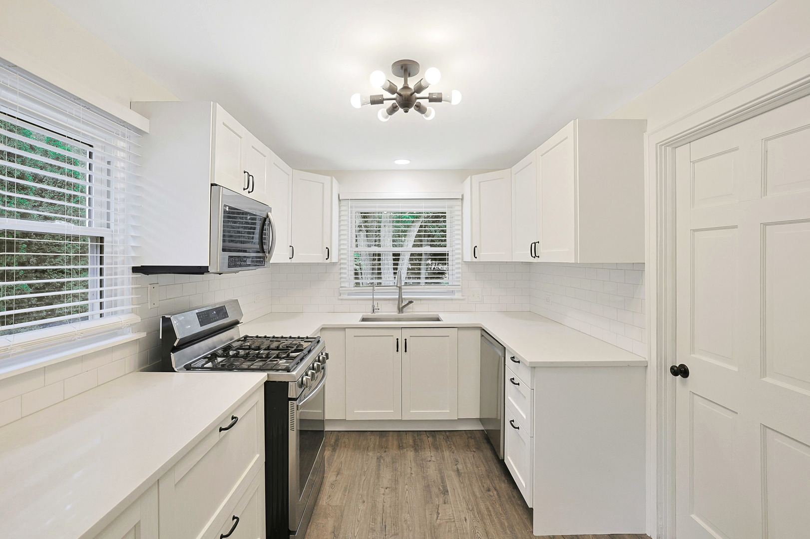 727 South Cook Street Barrington, IL 60010 - Photo 10 of 26 a kitchen with stainless steel appliances a sink stove and cabinets