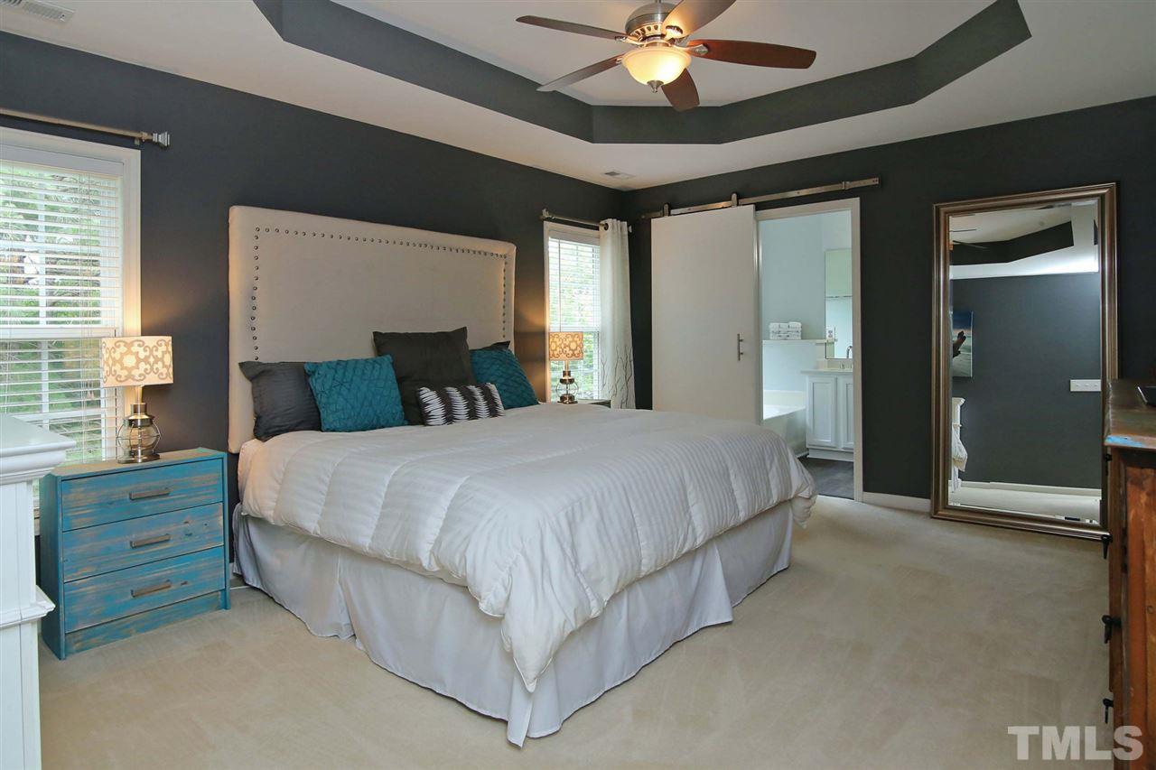 2525 Springfield Park Drive Raleigh, NC 27614 - Photo 13 of 25 Master suite features tray ceiling and custom barn door leading to updated master bath.