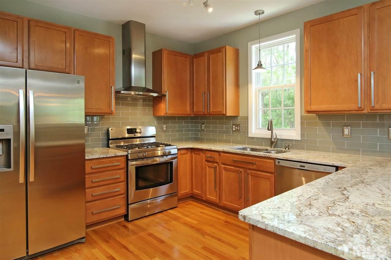 2525 Springfield Park Drive Raleigh, NC 27614 - Photo 7 of 25 All stainless steel appliances with modern range hood and gas range. Granite countertops. 42" cabinets with upgraded hardware. Modern glass tile backsplash.