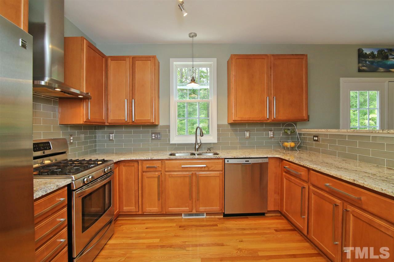 2525 Springfield Park Drive Raleigh, NC 27614 - Photo 8 of 25 All stainless steel appliances with modern range hood and gas range. Granite countertops. 42" cabinets with upgraded hardware. Modern glass tile backsplash.