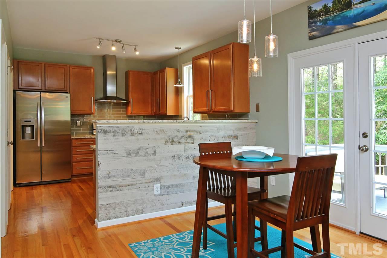 2525 Springfield Park Drive Raleigh, NC 27614 - Photo 10 of 25 Large breakfast area with custom barnwood accent wall and view into kitchen. French doors leading to deck and private backyard.