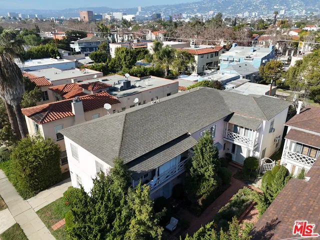 an aerial view of a house with a yard garage and lake view