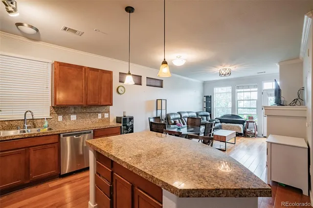 a kitchen with sink a counter and chairs