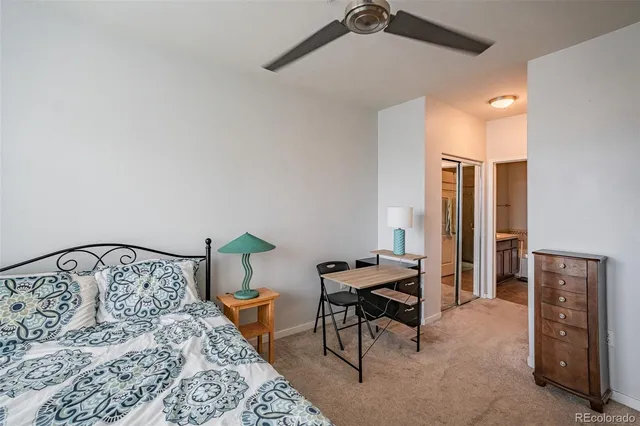 a bedroom with a bed and a table