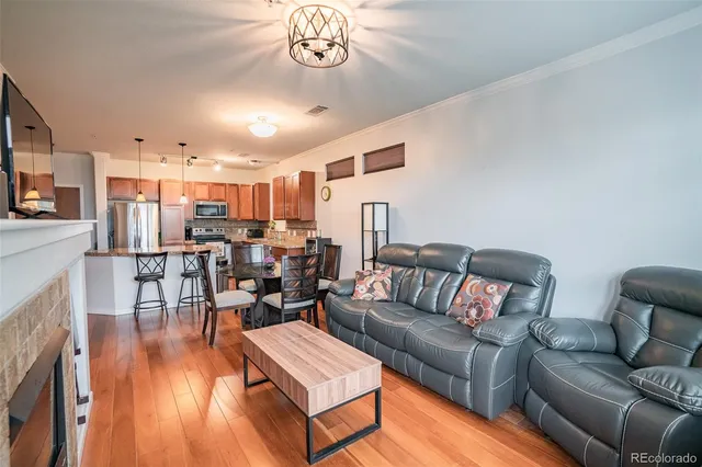 a living room with furniture kitchen view and a dining table