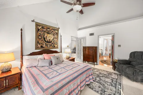 a bedroom with a bed and flat screen tv