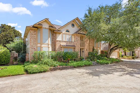 a front view of a house with a yard and a garage