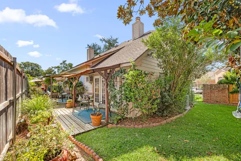 a view of a porch with furniture and floor to ceiling window