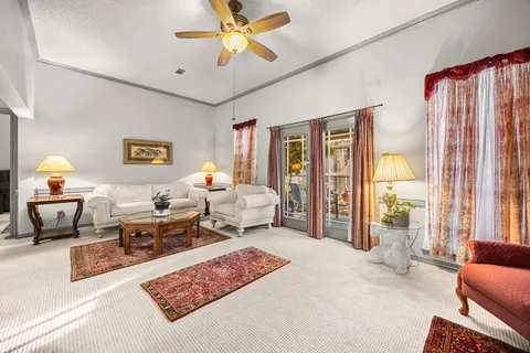 a living room with furniture and a chandelier