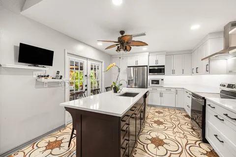 a large kitchen with a table and chairs
