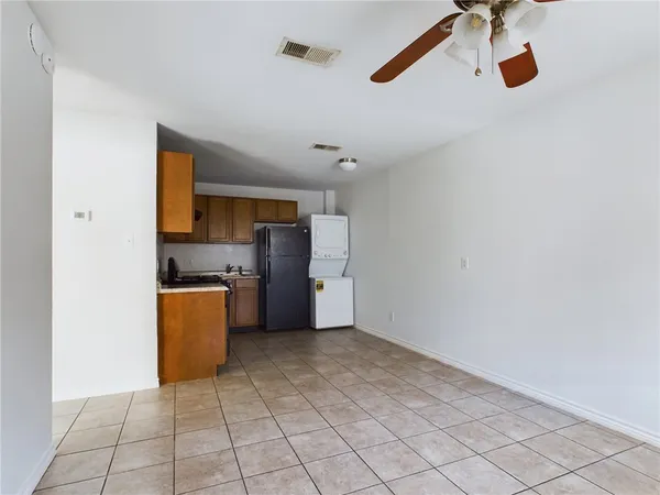 a view of kitchen with a sink cabinets and refrigerator
