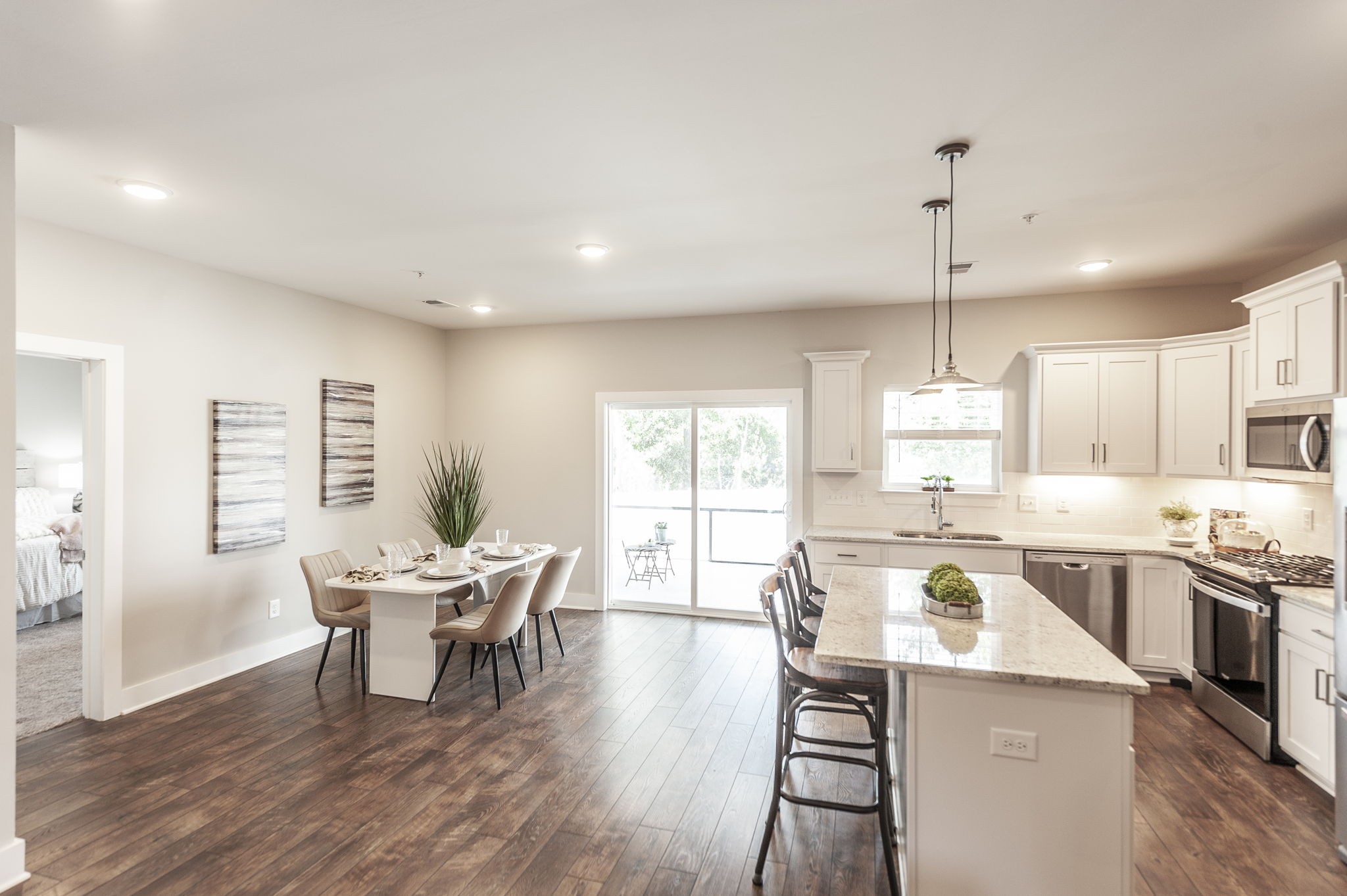 1144 Lock 4 Road, Unit A2 Gallatin, TN 37066 - Photo 20 of 66 a kitchen with a table chairs wooden floors and a view of living room