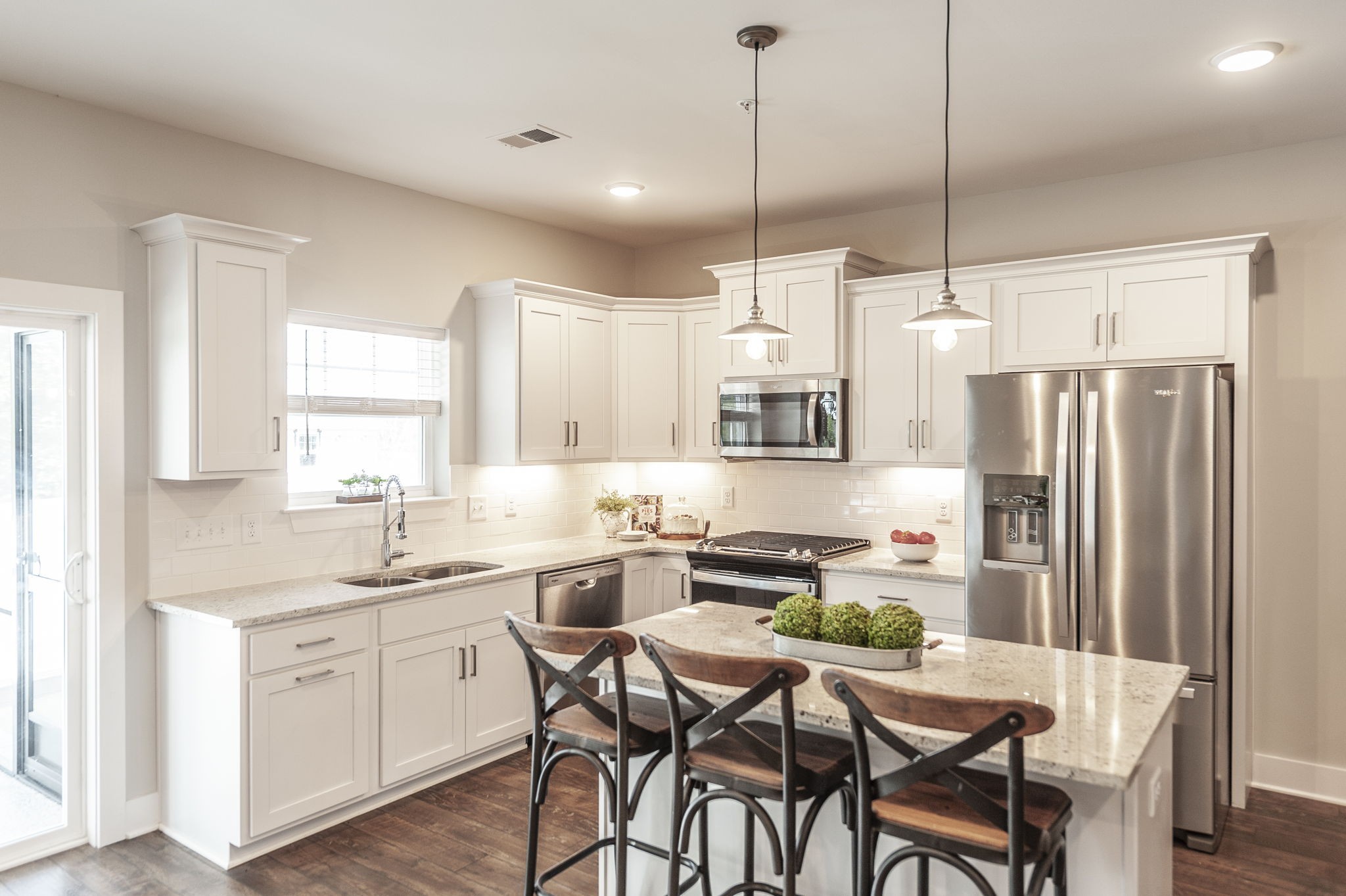 1144 Lock 4 Road, Unit A2 Gallatin, TN 37066 - Photo 22 of 66 a kitchen with stainless steel appliances kitchen island granite countertop a dining table chairs and white cabinets