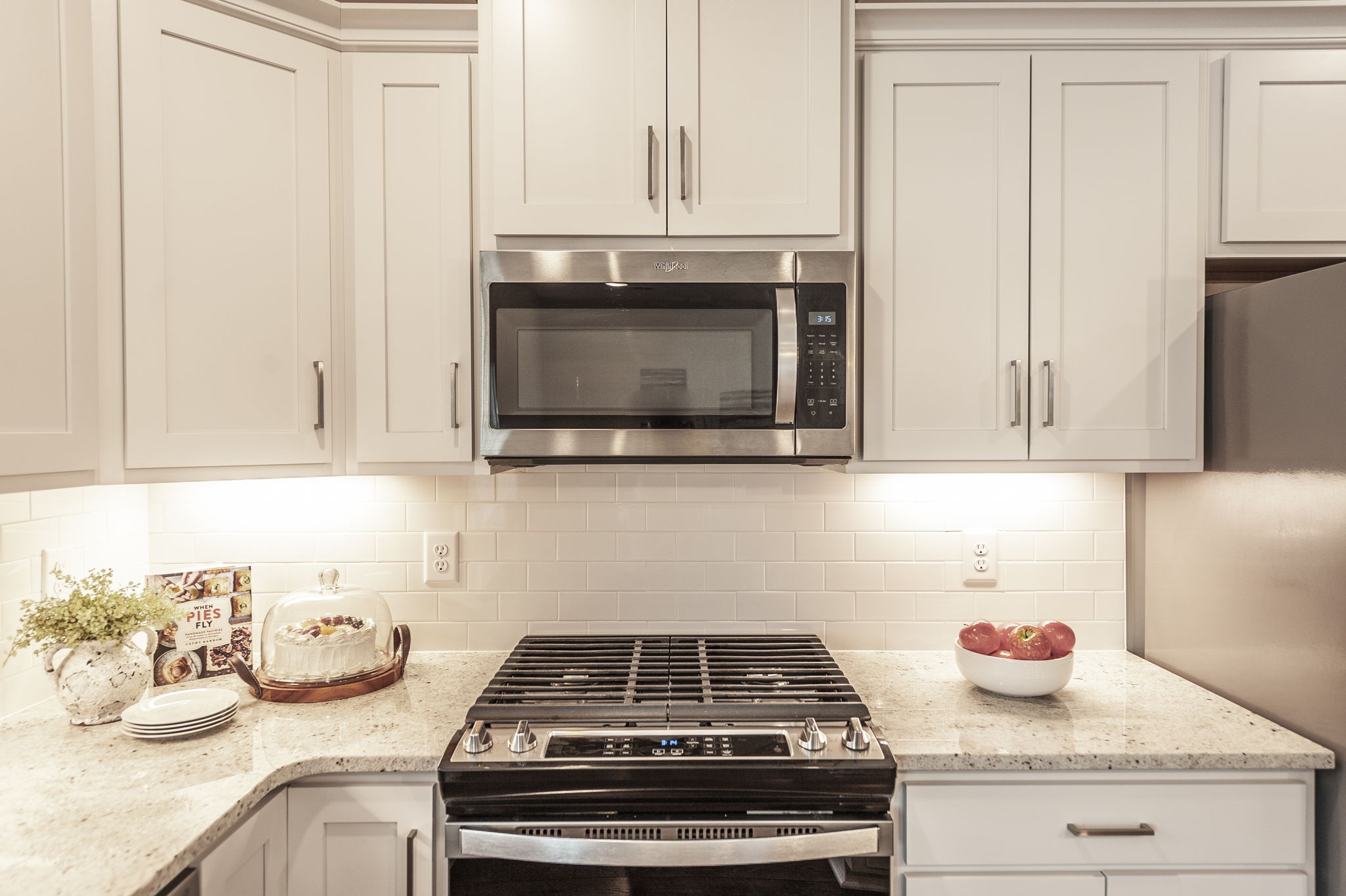 1144 Lock 4 Road, Unit A2 Gallatin, TN 37066 - Photo 26 of 66 a kitchen with granite countertop white cabinets and a stove top oven