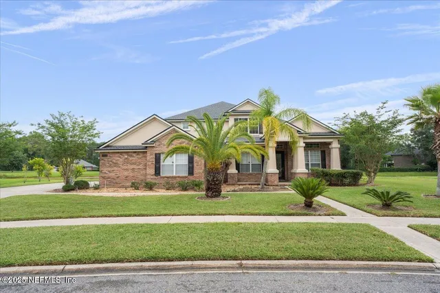 a front view of house with yard and green space