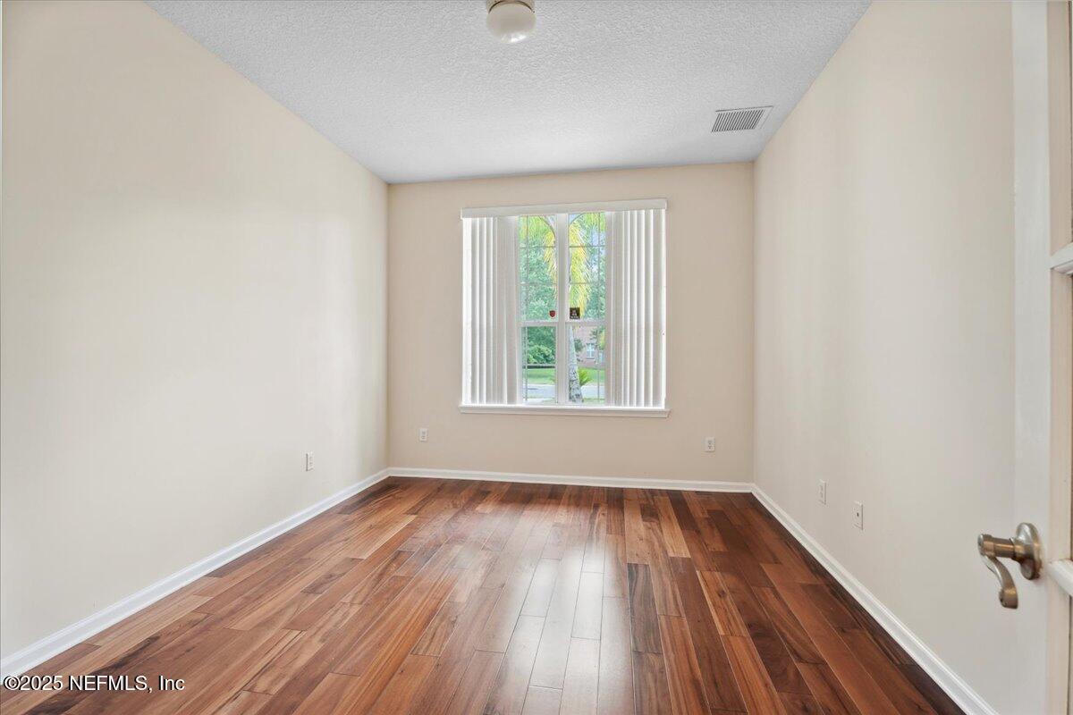 1127 Emilys Walk Lane West Jacksonville, FL 32221 - Photo 11 of 43 an empty room with wooden floor and windows