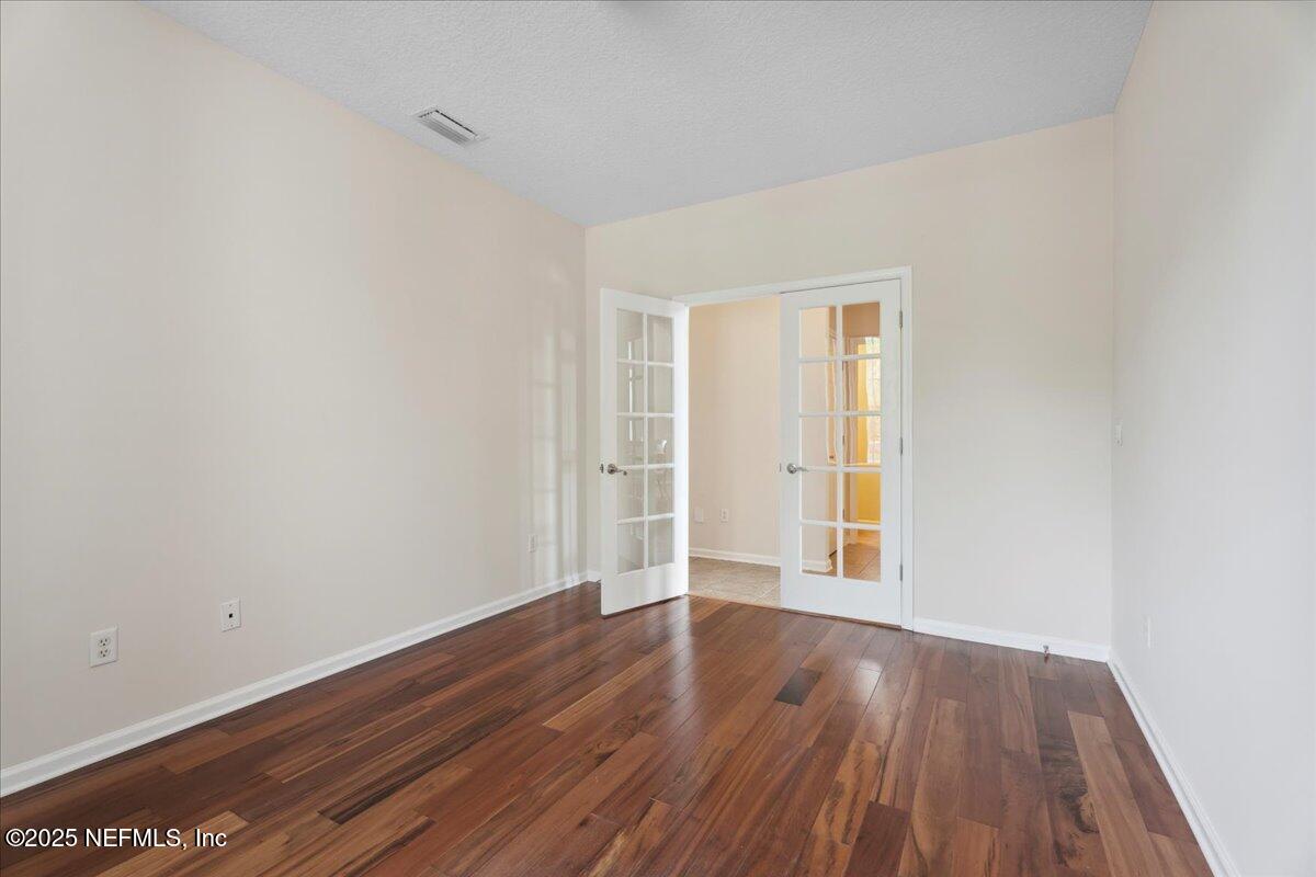1127 Emilys Walk Lane West Jacksonville, FL 32221 - Photo 12 of 43 an empty room with wooden floor and windows