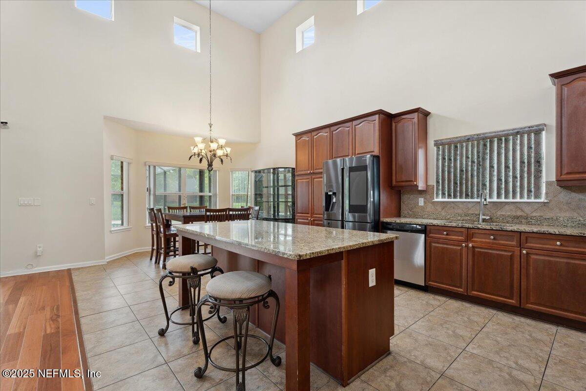 1127 Emilys Walk Lane West Jacksonville, FL 32221 - Photo 14 of 43 a kitchen with granite countertop cabinets a sink and stainless steel appliances