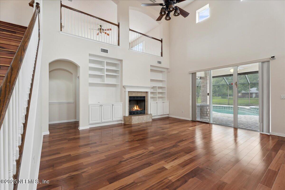 1127 Emilys Walk Lane West Jacksonville, FL 32221 - Photo 15 of 43 wooden floor in an empty room with a fireplace