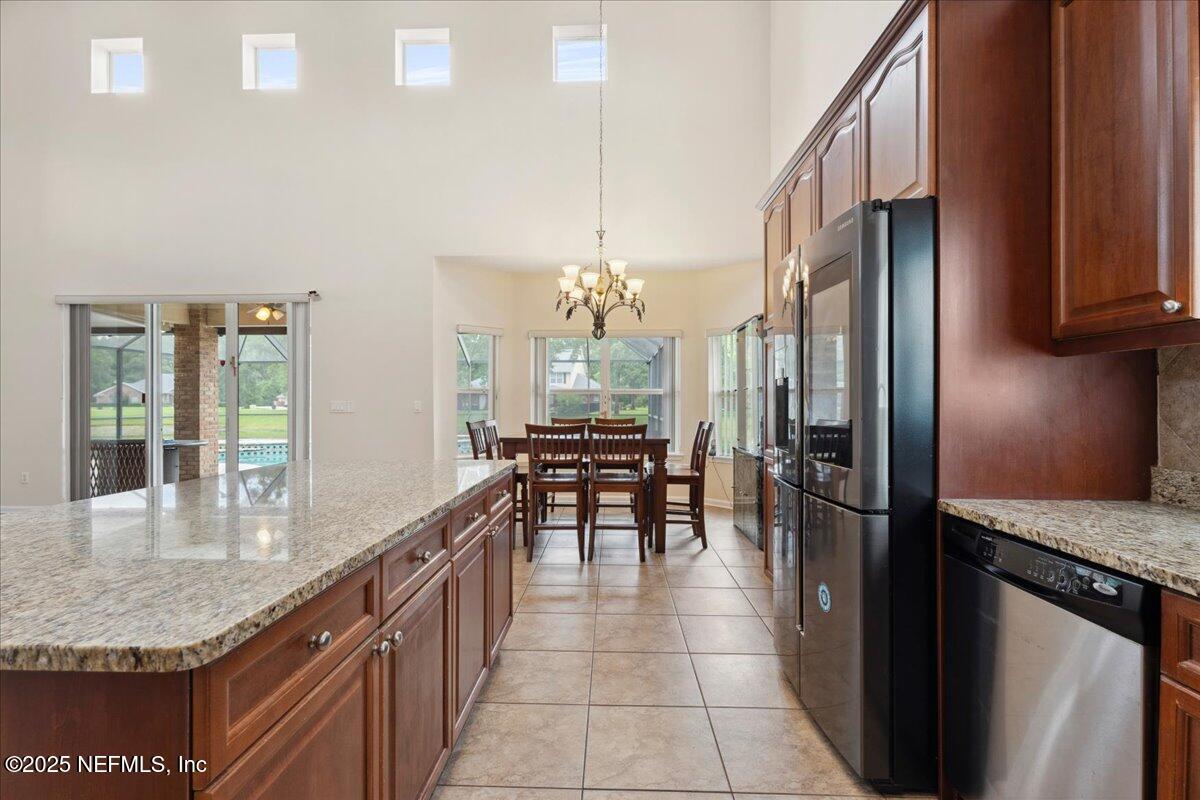 1127 Emilys Walk Lane West Jacksonville, FL 32221 - Photo 16 of 43 a kitchen with granite countertop counter top space and stainless steel appliances
